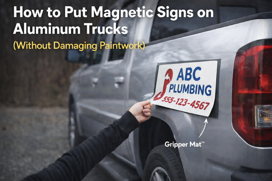 Magnetic business sign being applied to an aluminum truck using a Gripper Mat to protect paintwork and allow magnets to stick.
